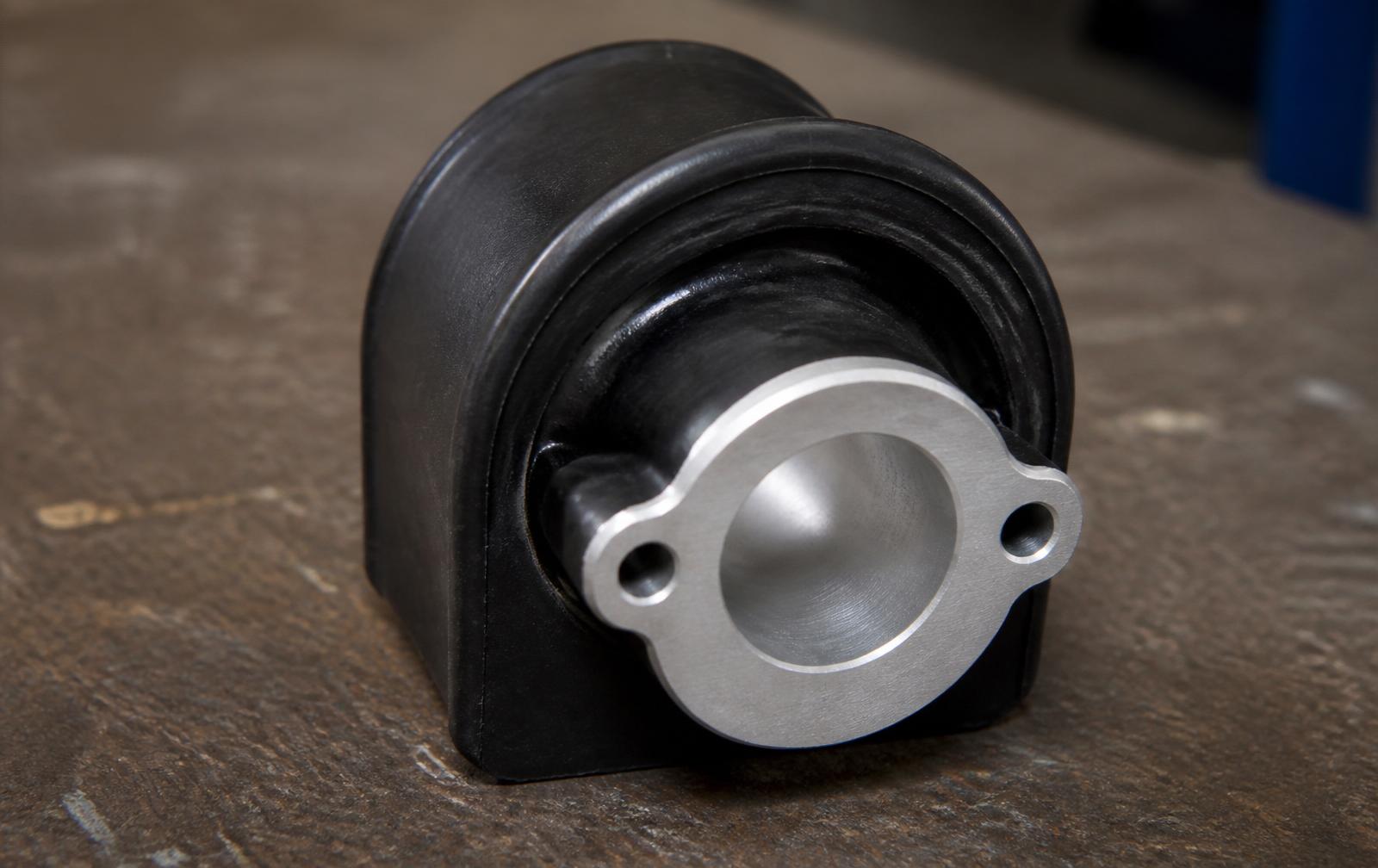 Cross-section of a bonded rubber-to-metal component on a workshop bench